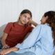 teen and mom sitting on couch looking at each other