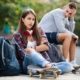 teen sitting with arms crossed and skateboard
