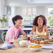 vulnerability-is-not-a-virtue A happy family laughing and talking at the dinner table